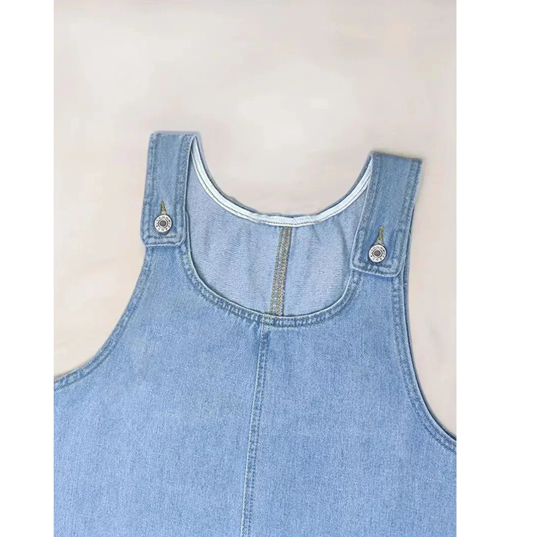 Light blue denim-look dress neckline with scoop collar and buttoned shoulder tabs