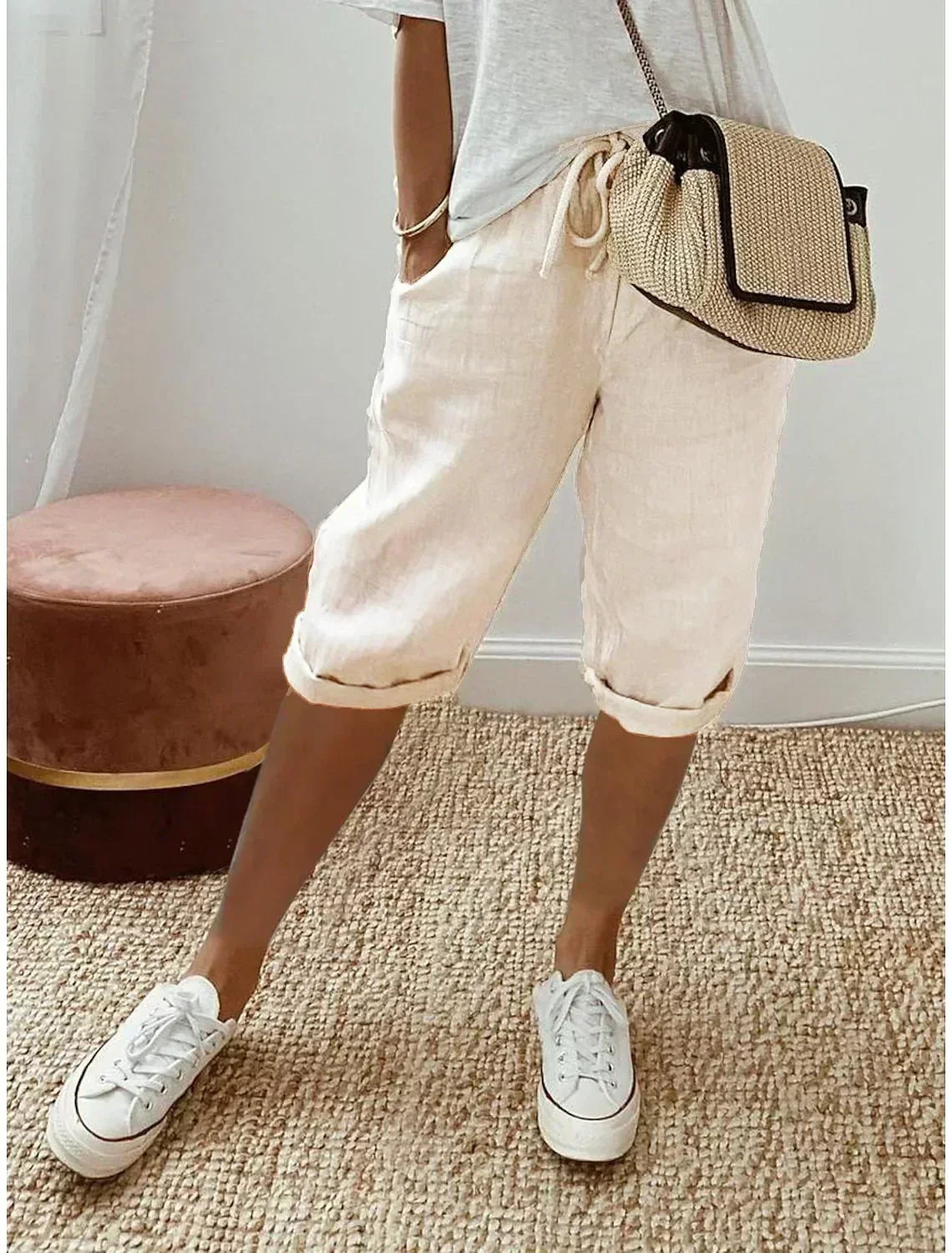 Lightweight summer shorts in off-white, rolled hem, drawstring waist and side pockets.