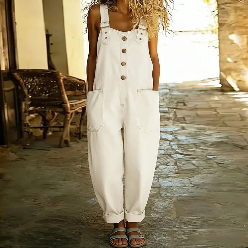 White denim overall with adjustable straps and button front; two chest pockets.