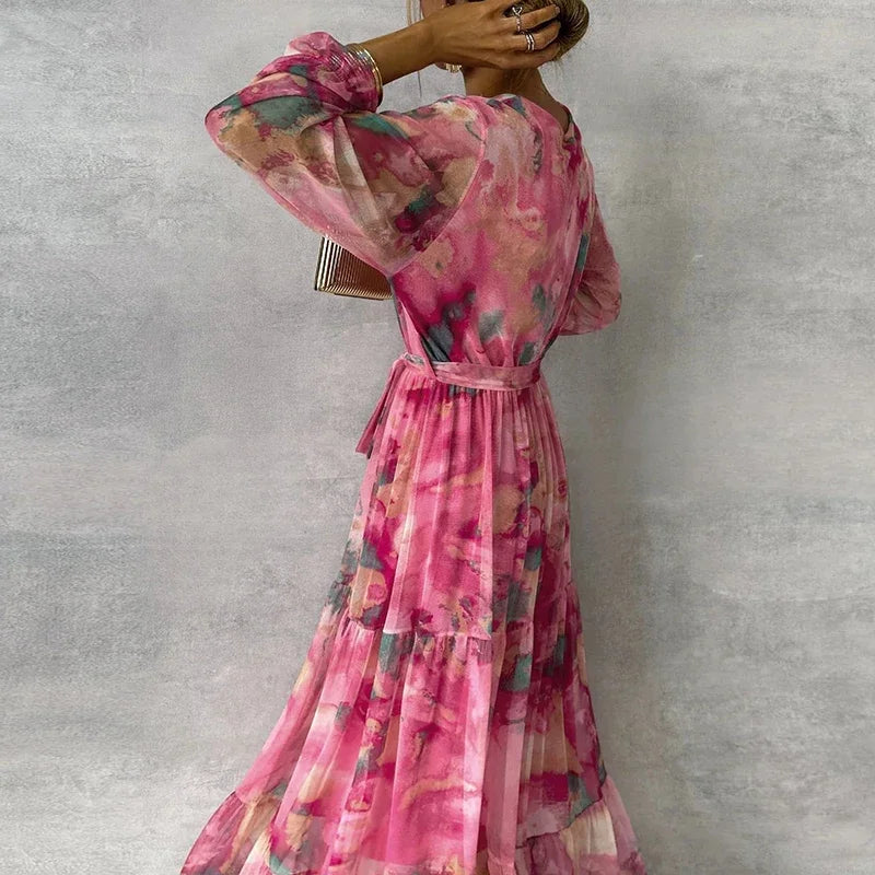 Floral maxi dress in pink with V-neck wrap and tiered skirt, long puff sleeves, sash waist