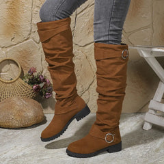 Knee-high brown suede boots with buckle rings and chunky lug sole