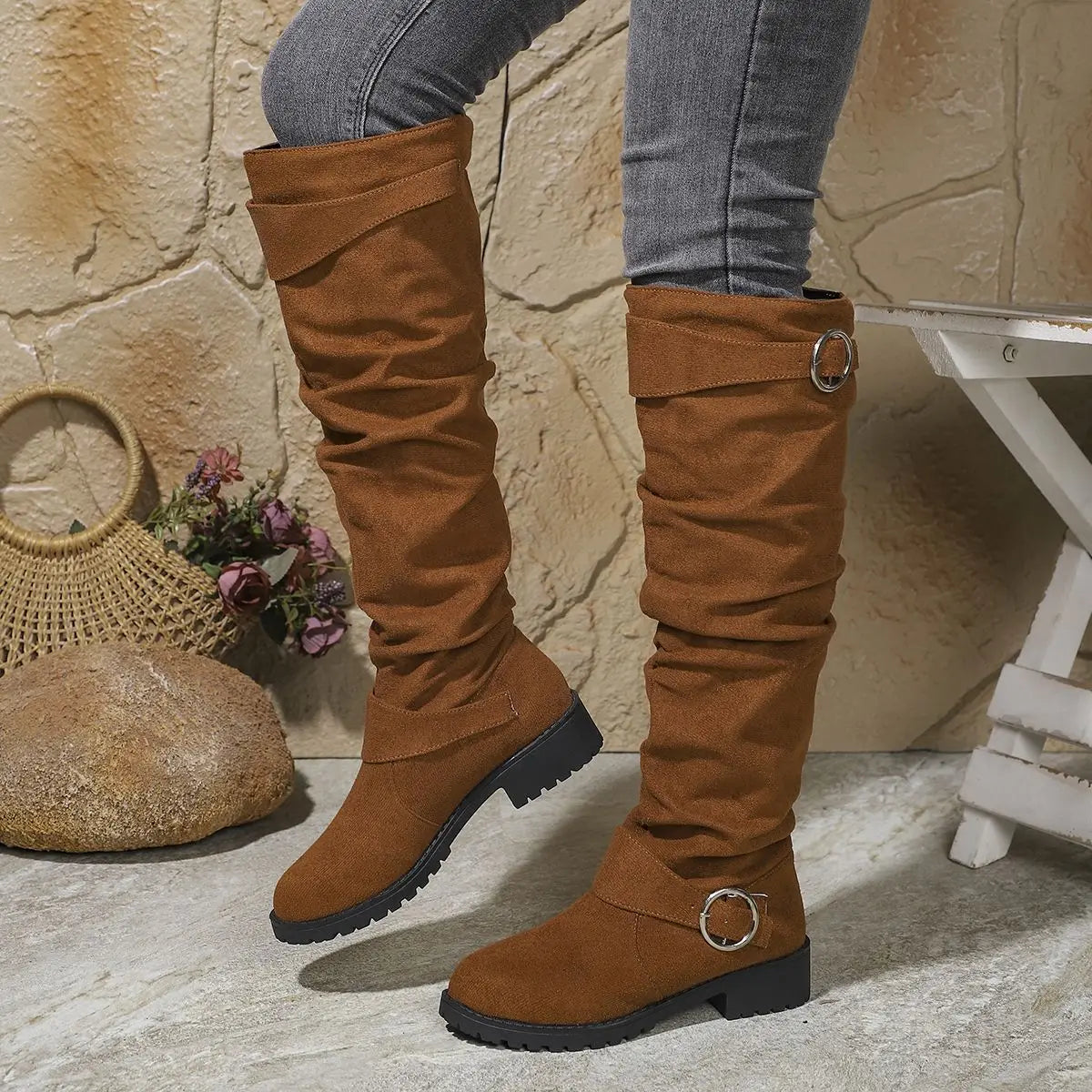 Knee-high brown suede boots with buckle rings and chunky lug sole