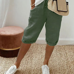 Lightweight summer shorts in dark green, rolled hem, drawstring waist and side pockets.