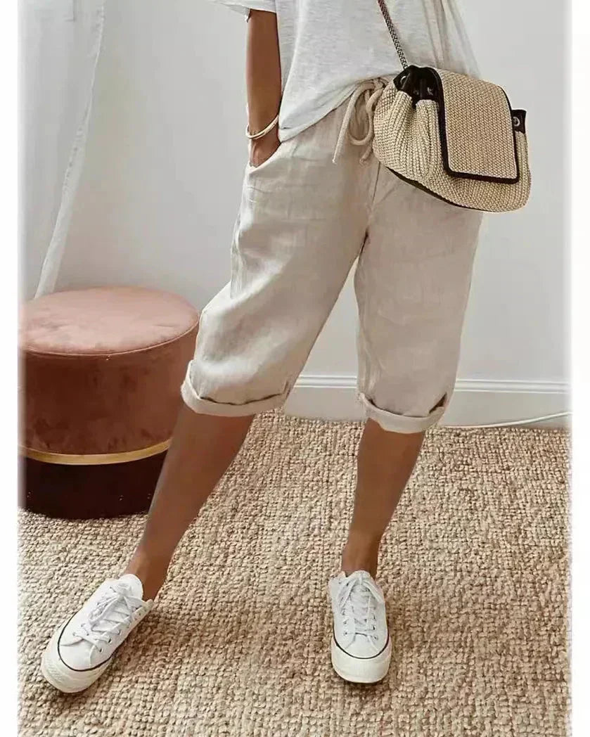 Lightweight summer shorts in cream, rolled hem, drawstring waist and side pockets.