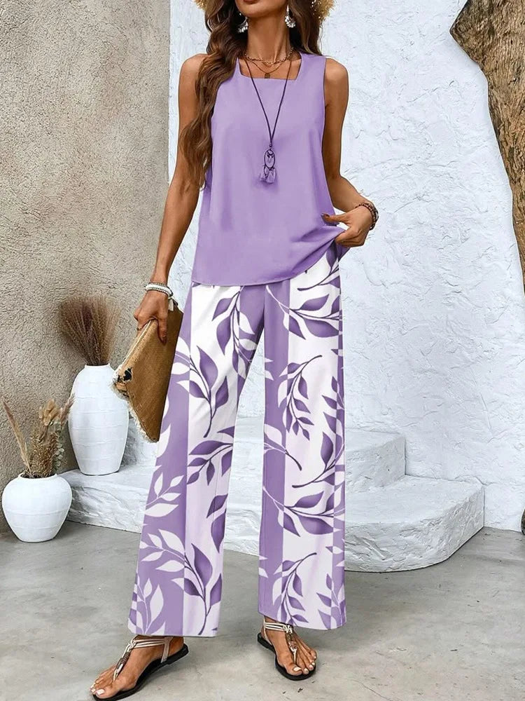 Completo due pezzi viola: top senza maniche e pantaloni ampi a foglie bianche
