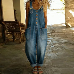 Light blue denim overall with adjustable straps, button front, and chest pockets.
