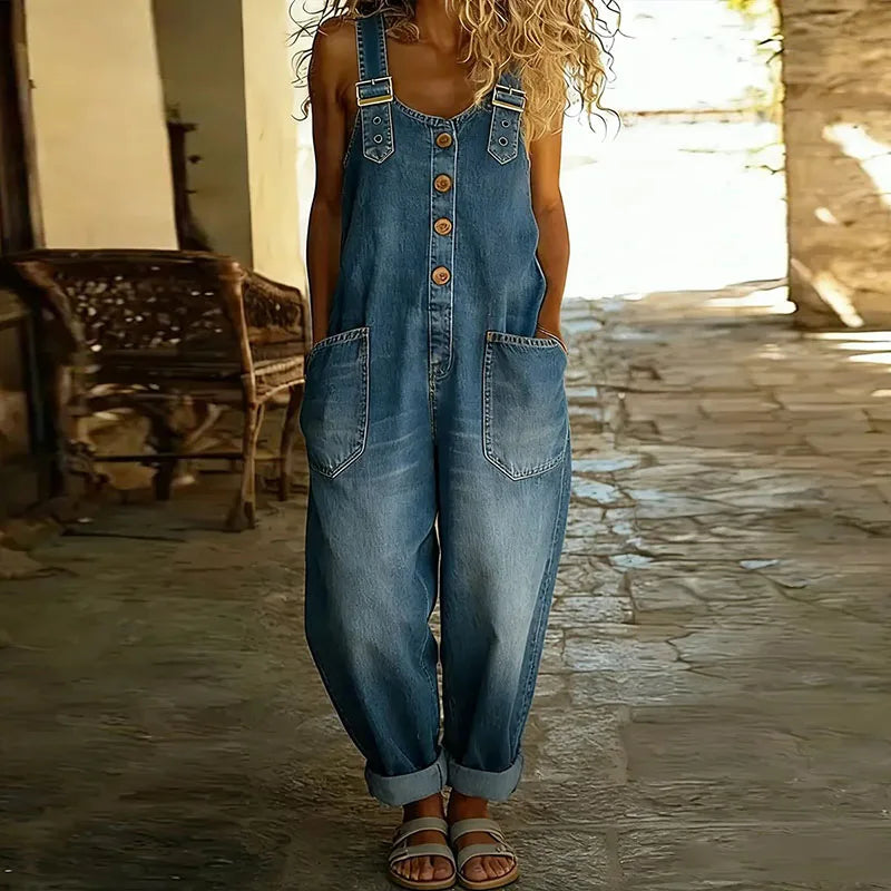 Light blue denim overall with adjustable straps, button front, and chest pockets.
