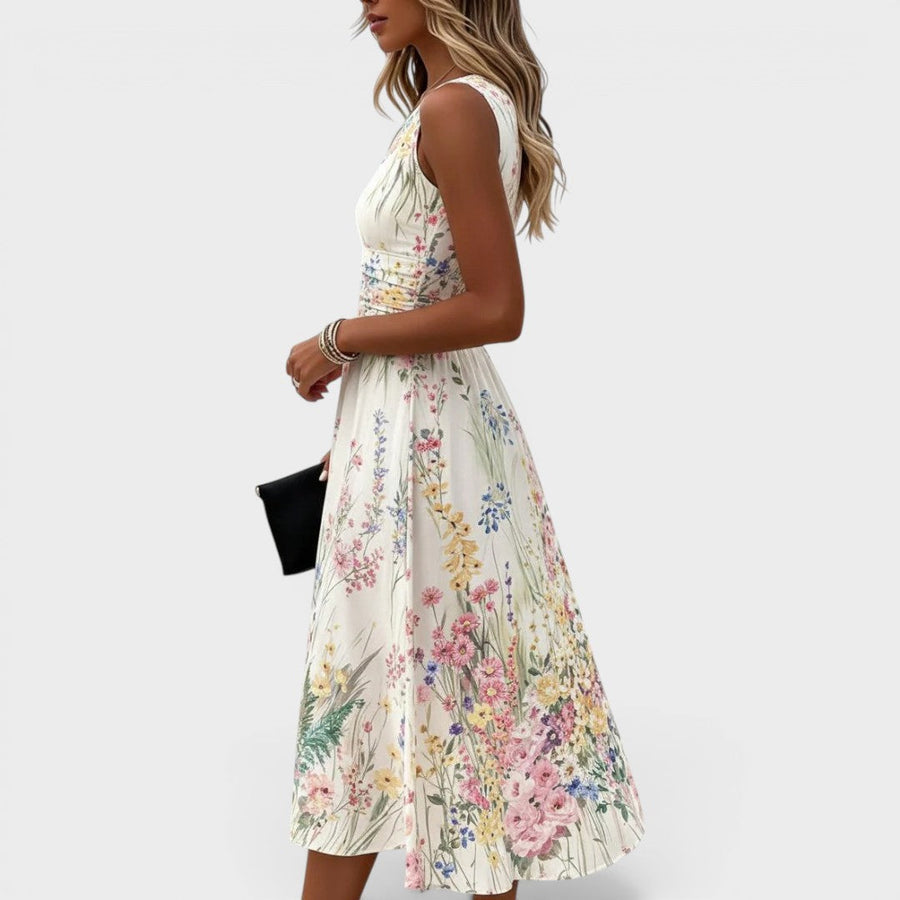 White sleeveless floral midi dress with cinched waist and pleated skirt