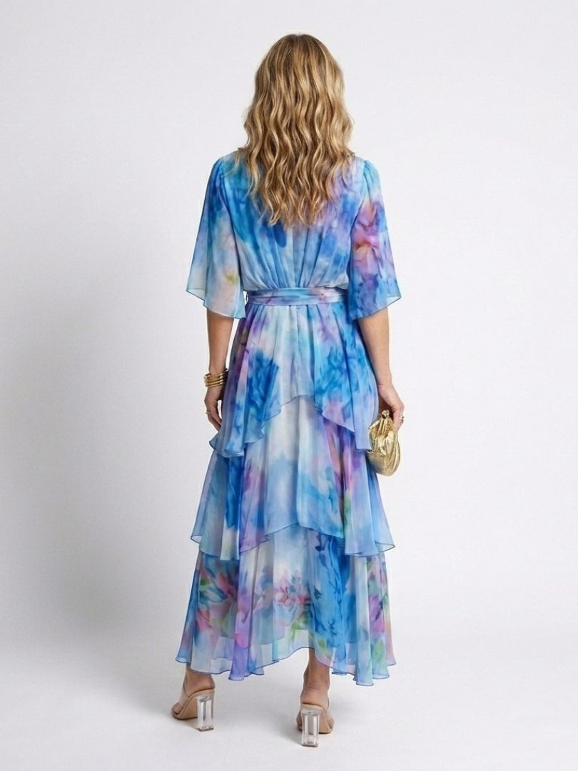 Back view of blue watercolor print tie-waist V-neck maxi dress with layered ruffle tiers