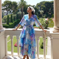 Blue watercolor print V-neck tie-waist maxi dress on a balcony, layered ruffle tiers