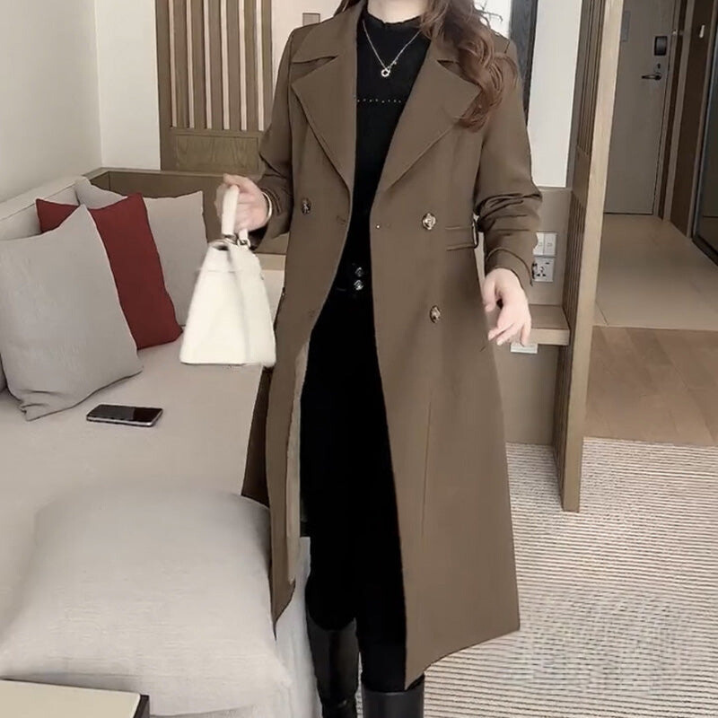 Nadine khaki trench coat with notched lapels, double-breasted buttons, waist belt and long length