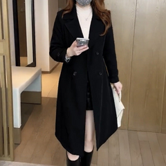 Nadine black trench coat with notched lapels, double-breasted buttons, long asymmetric hem
