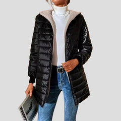 Hooded quilted puffer coat in black with teddy-fleece lining, zip pockets, and hood.
