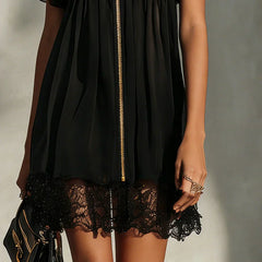 Black zip-front mini dress close-up: gold zipper and lace hem trim