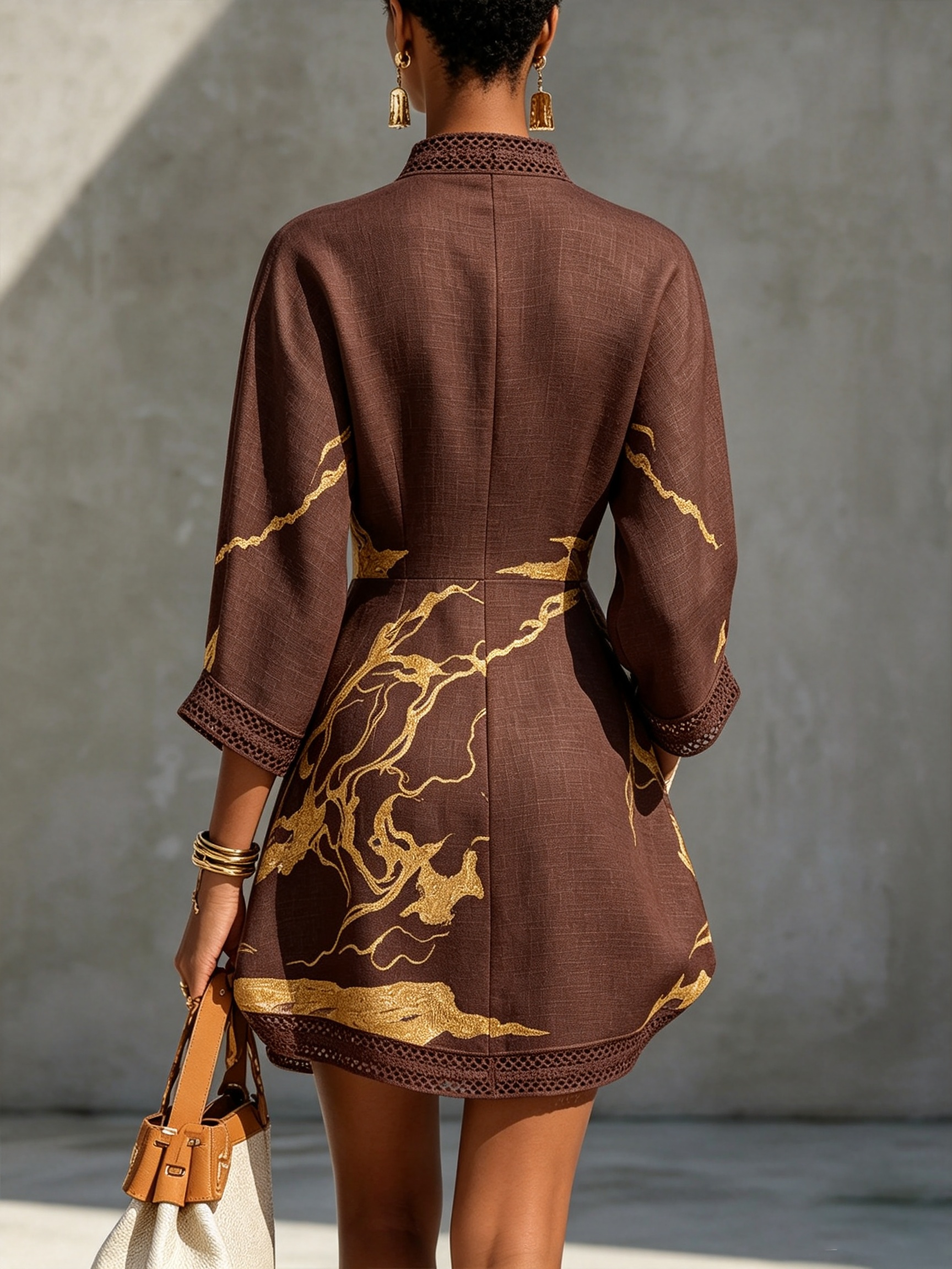 Back view dark brown lace midi dress with gold motif embroidery and lace-trim hem