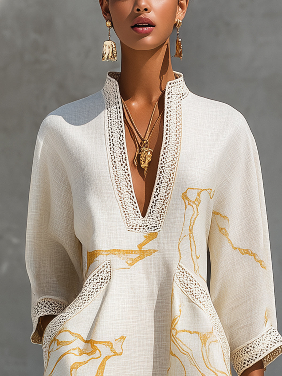 Ivory V-neck midi dress with ornate lace trim and gold marble pattern