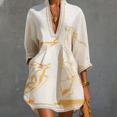 Ivory midi dress with V-neck lace trim and gold marbled panel print