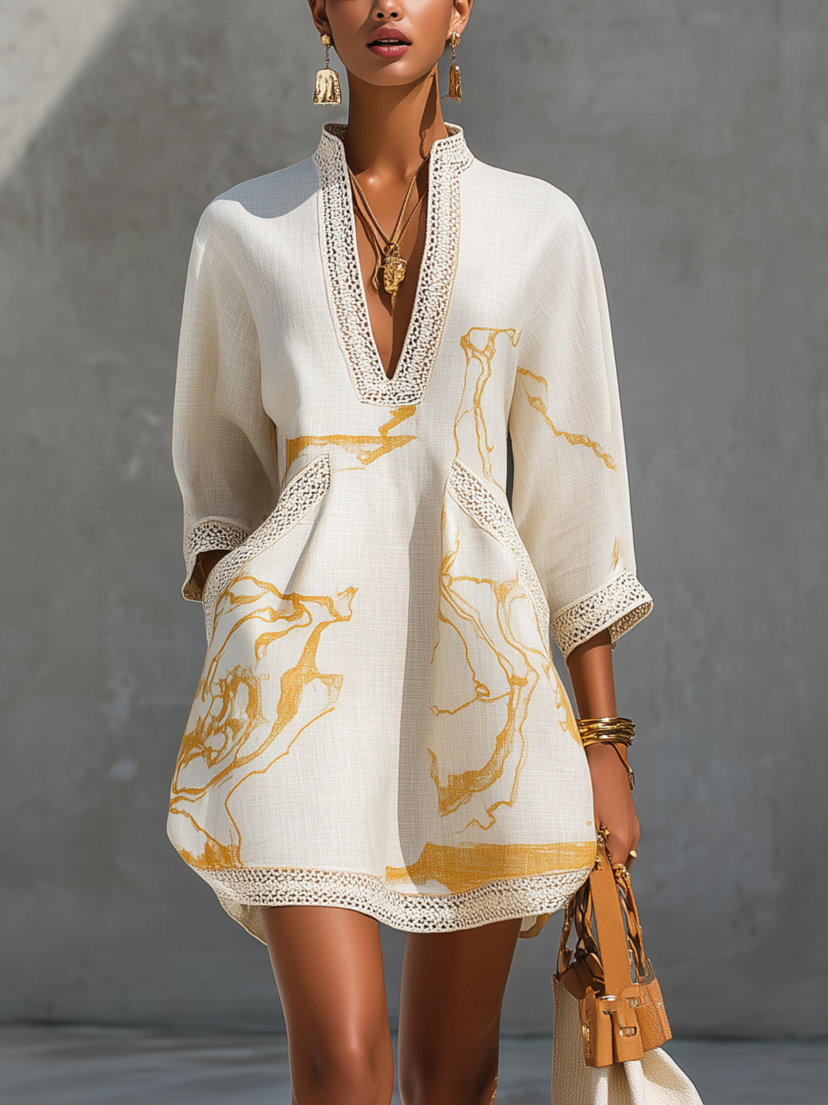Ivory lace midi dress with V-neck, lace-trim cuffs, and gold abstract print