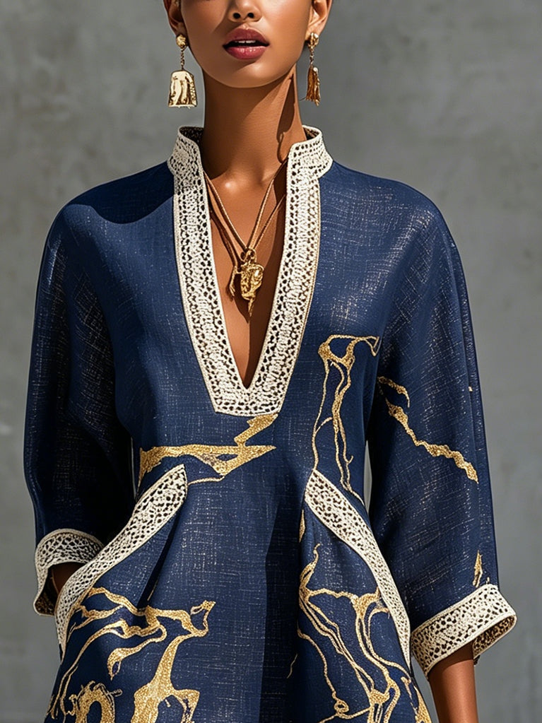 Navy midi lace-trim dress with gold print and deep V neckline; close-up