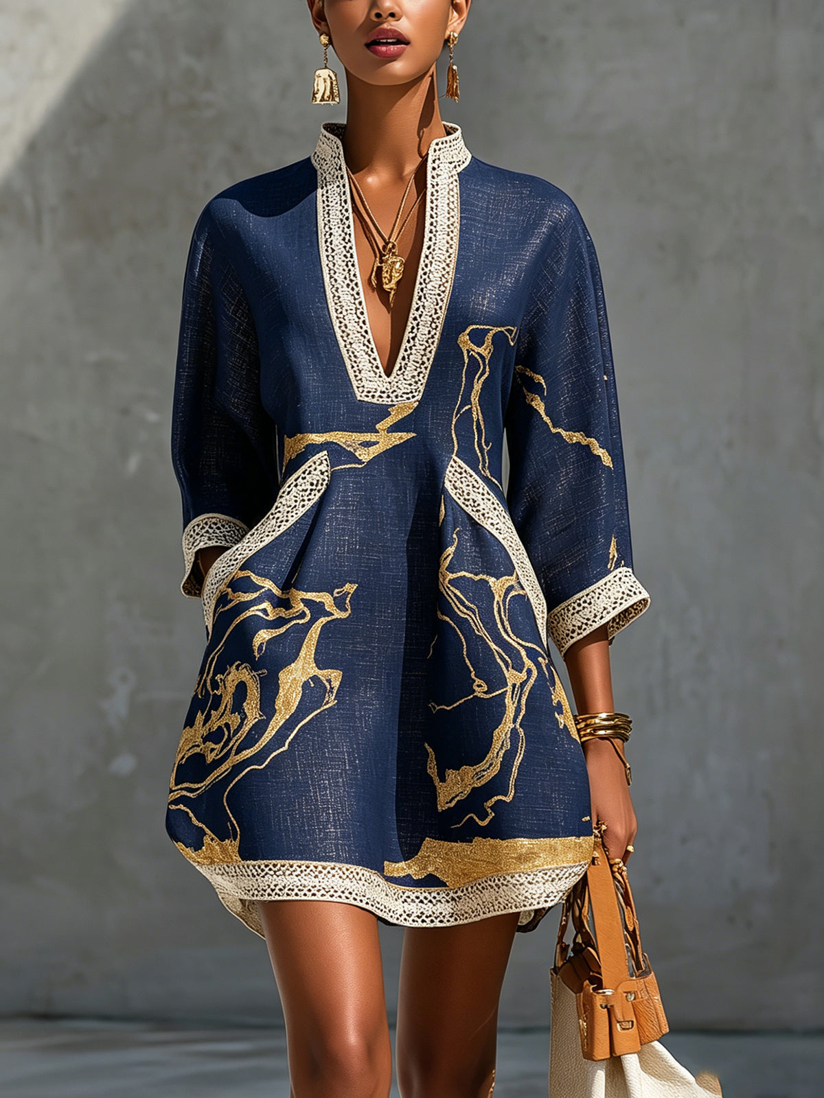 Navy lace midi dress with V-neck, three-quarter sleeves, and gold abstract print