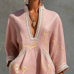 Pink lace-trim midi dress close-up with deep V neckline, gold motifs, quarter sleeves