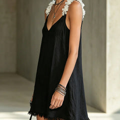 Black V-neck midi dress, floral shoulder appliques and short fringe hem.