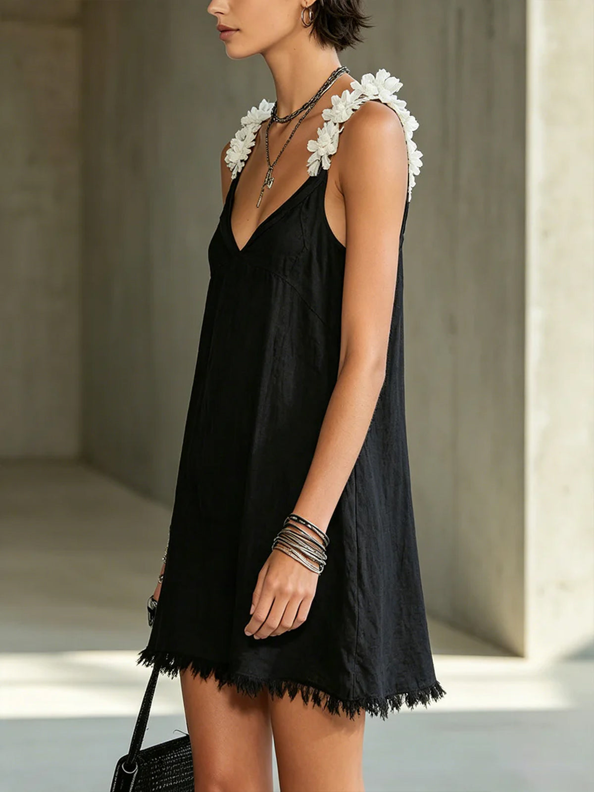 Black V-neck midi dress, floral shoulder appliques and short fringe hem.