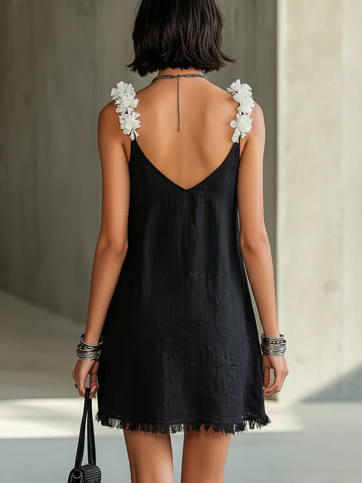 Black midi dress backless V-back with floral shoulder appliques and fringe hem.