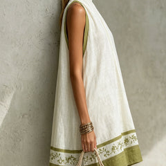 White sleeveless halter midi dress with green border and floral hem motif