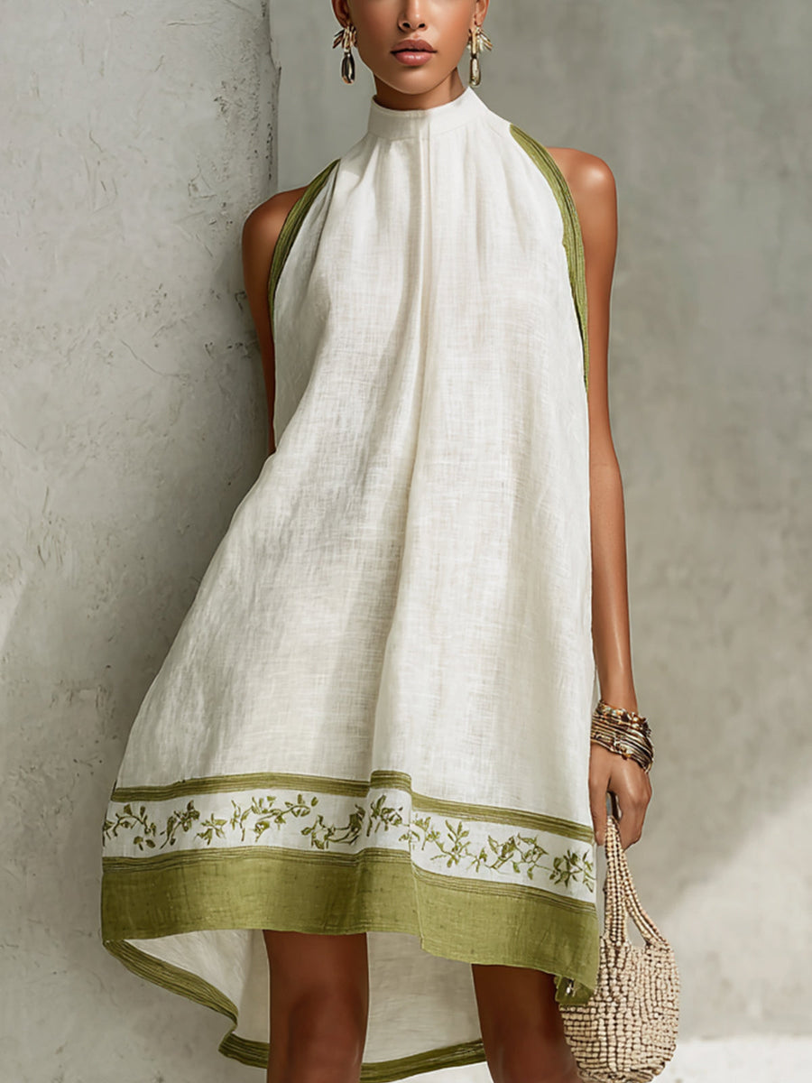 White halter midi dress with high neckline and green floral hem border