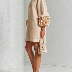 Tan button-front midi dress with front buttons and large flower applique on sleeve