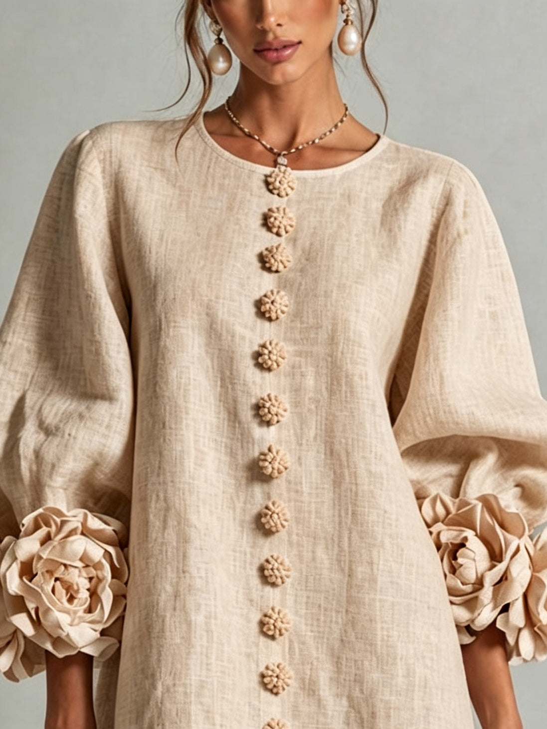 Beige linen midi dress close-up, round neck and floral button trim down front