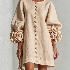 Beige button-front midi dress with round neck, long puff sleeves, and floral trim