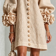 Beige button-front midi dress lower detail with floral buttons and straight hem