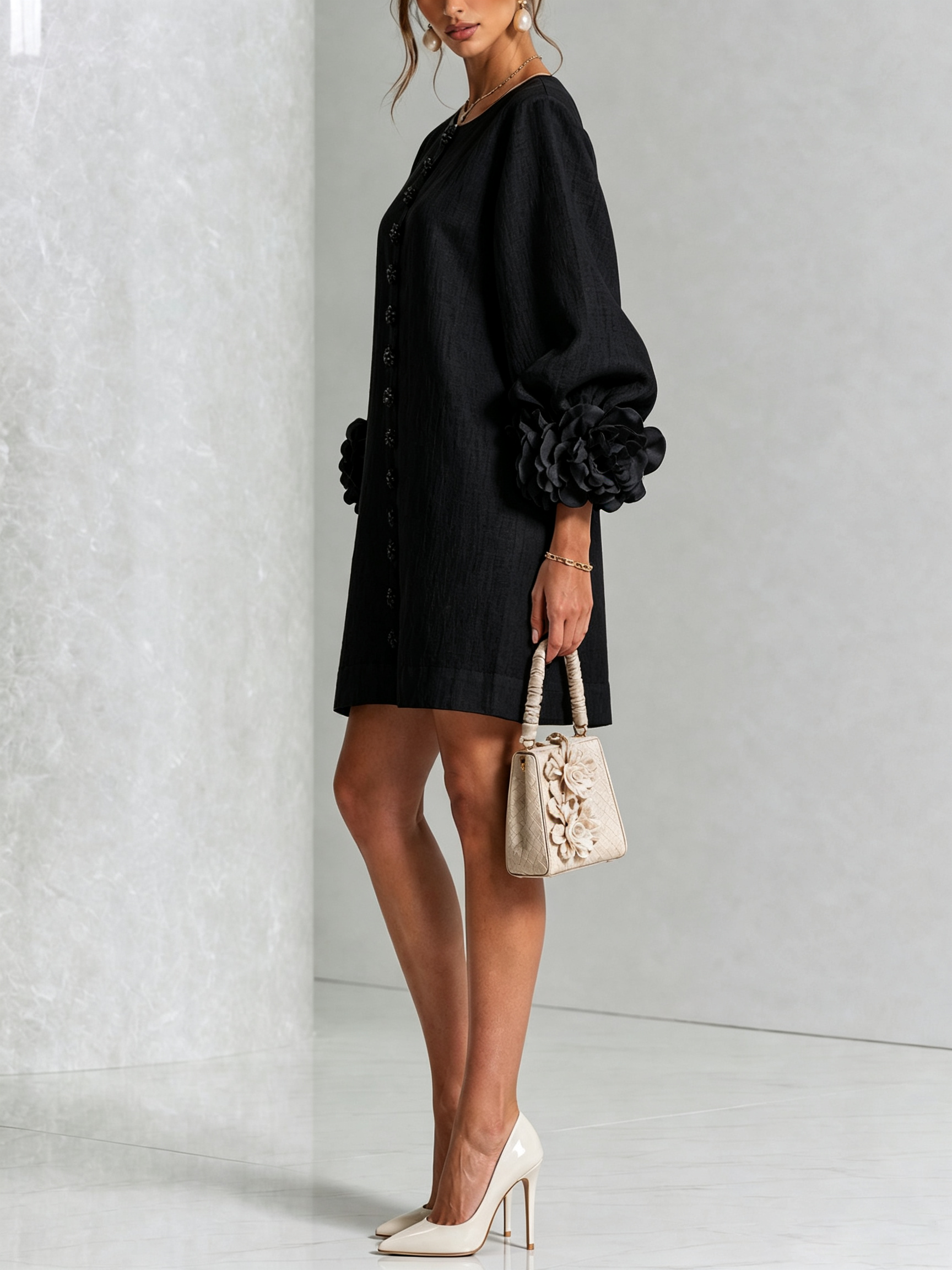 Black button-front midi dress, side view, puff sleeves with rosette cuffs