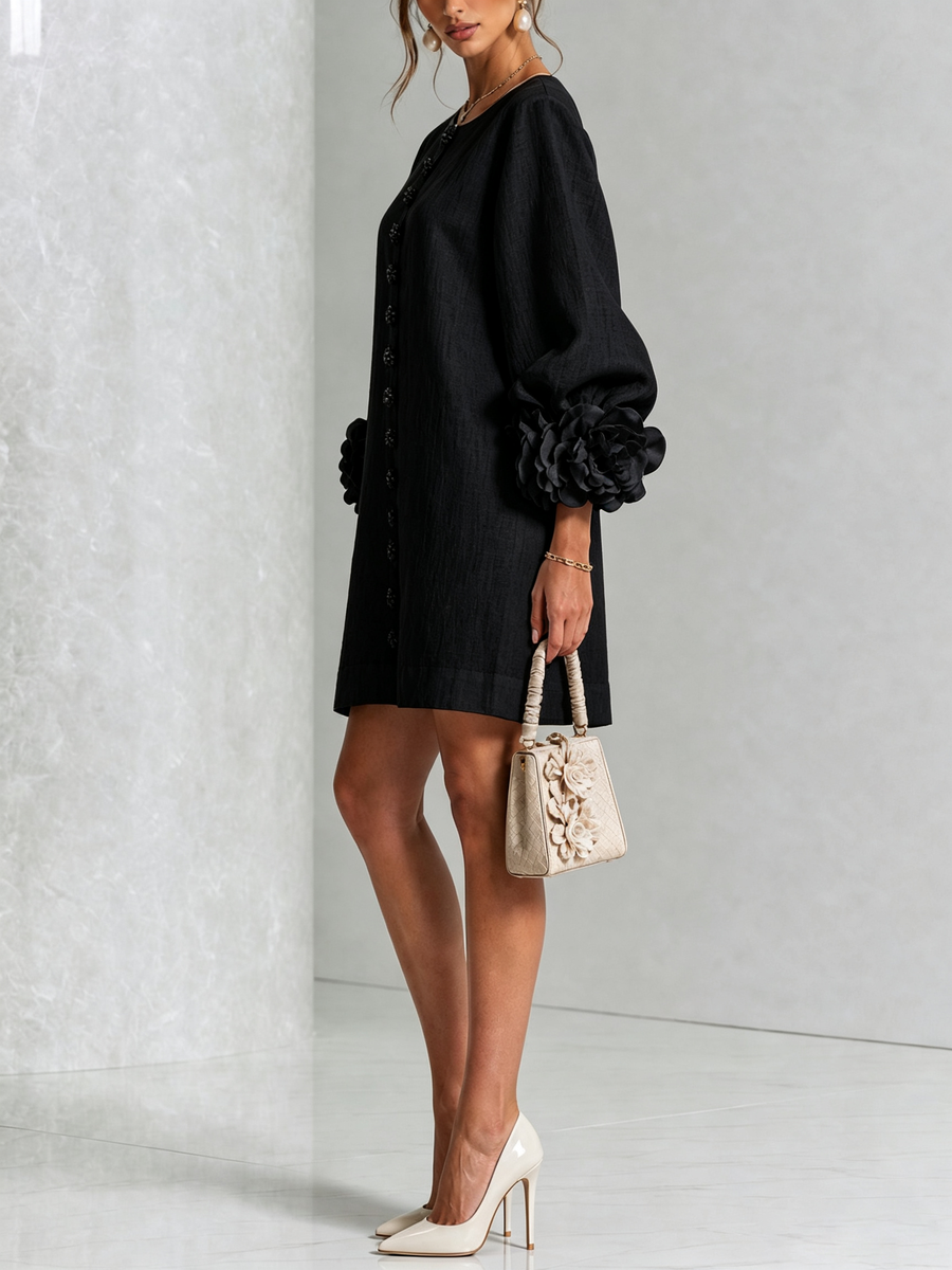 Black button-front midi dress, side view, puff sleeves with rosette cuffs