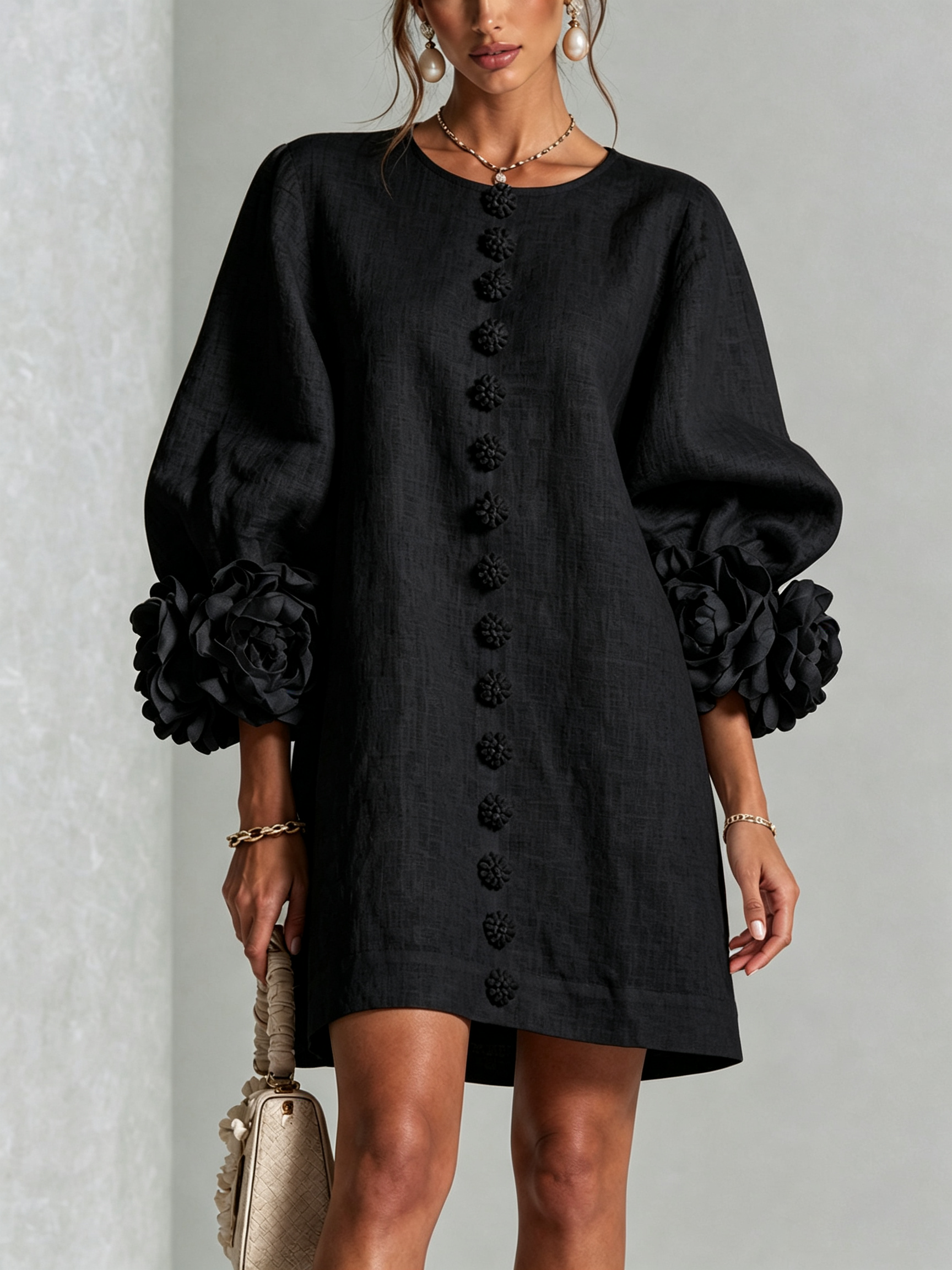 Black button-front midi dress with floral front detail and puff sleeves, rosette cuff