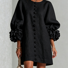 Dark button-front midi dress with long sleeves and oversized rosette cuff accents