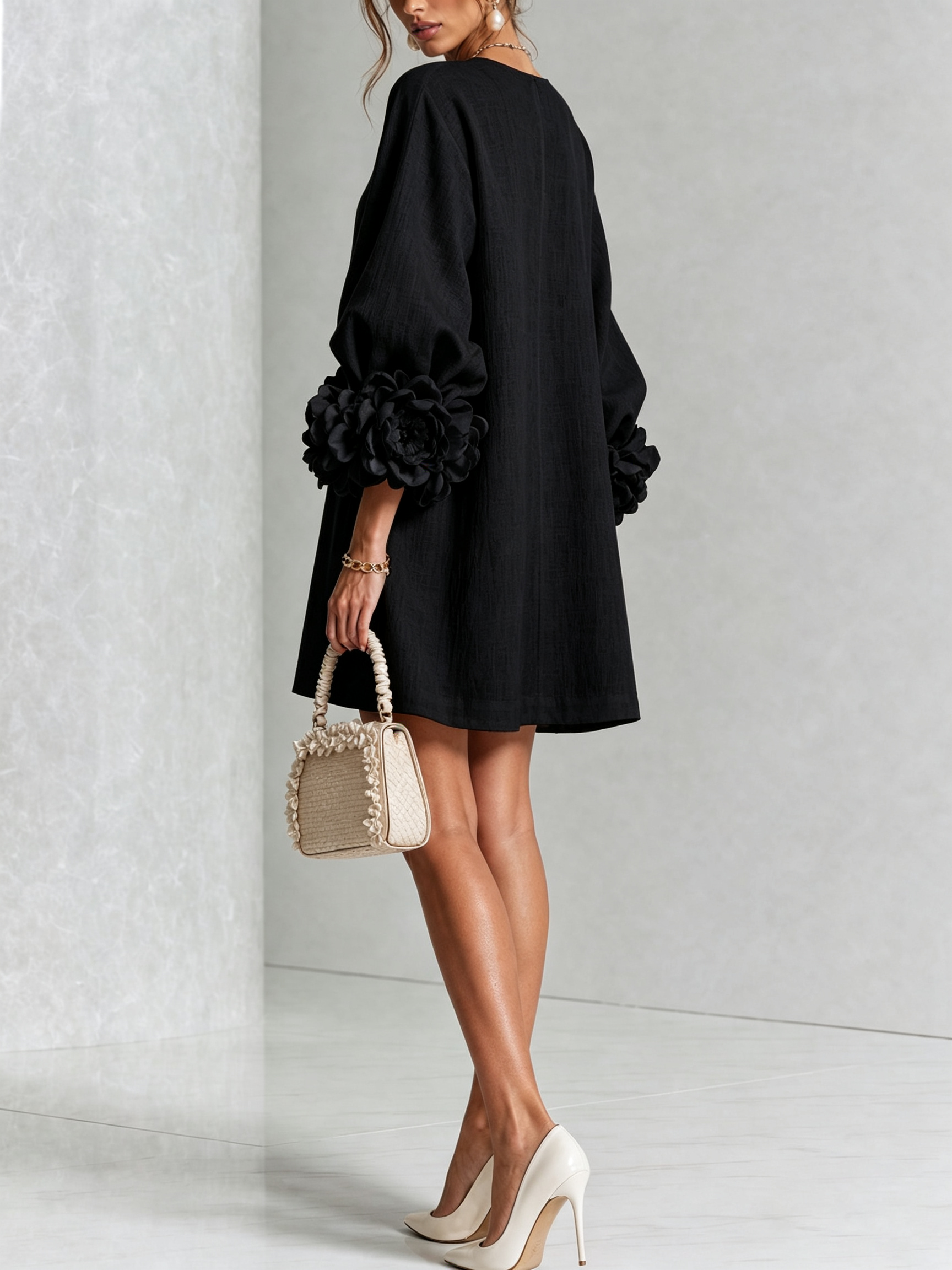 Black button-front midi dress with rosette cuff detail, side angle