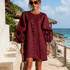 Burgundy midi dress with long puff sleeves, rosette cuffs, and embroidered center placket