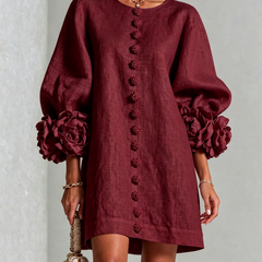 Burgundy linen midi dress with round neckline, long sleeves, and vertical embroidered buttons