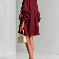 Burgundy linen midi dress with long sleeves, rosette cuffs, and V-back neckline detail