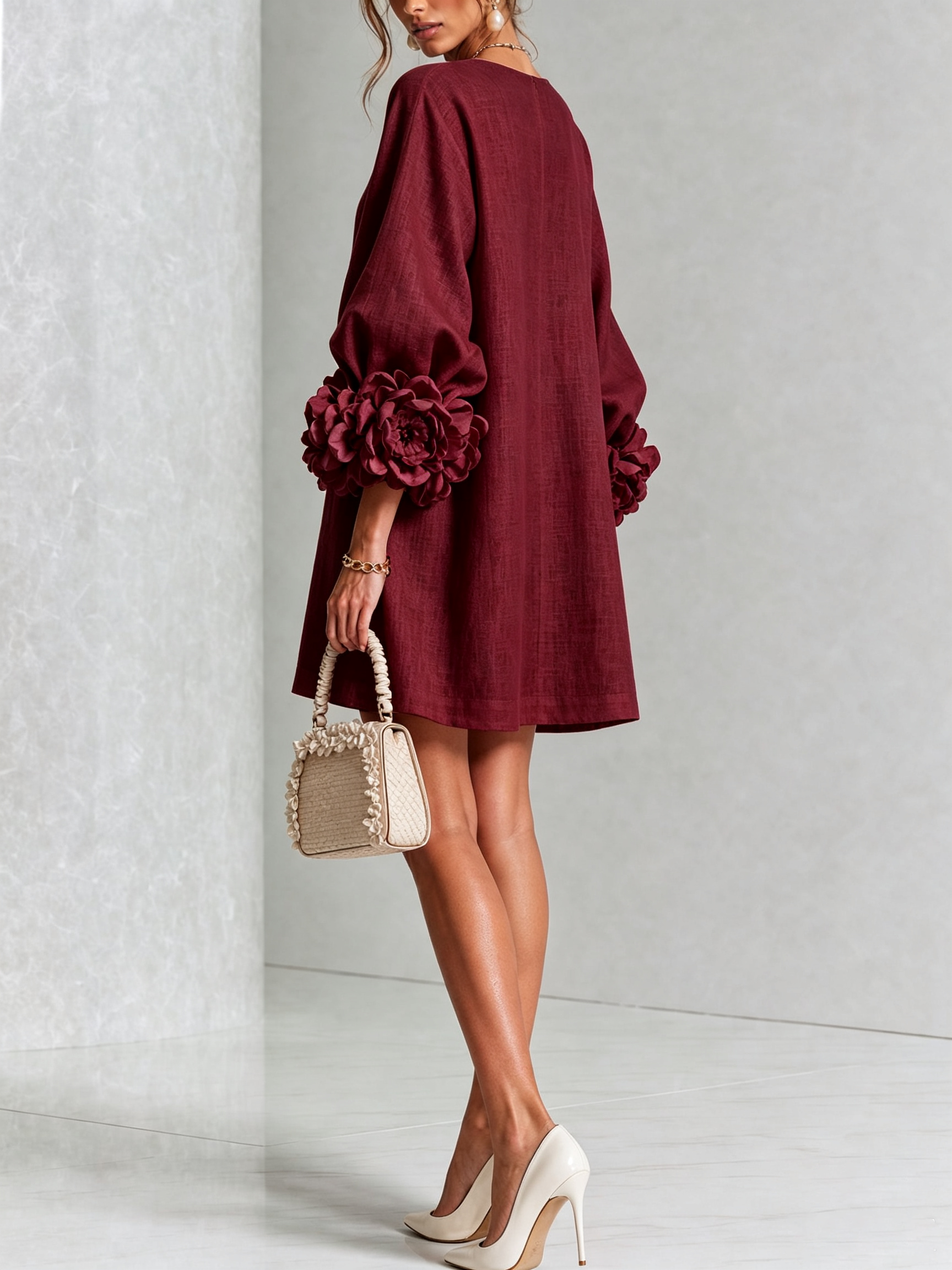 Burgundy button-front mini dress with embroidered front placket and oversized rosette sleeve cuffs.