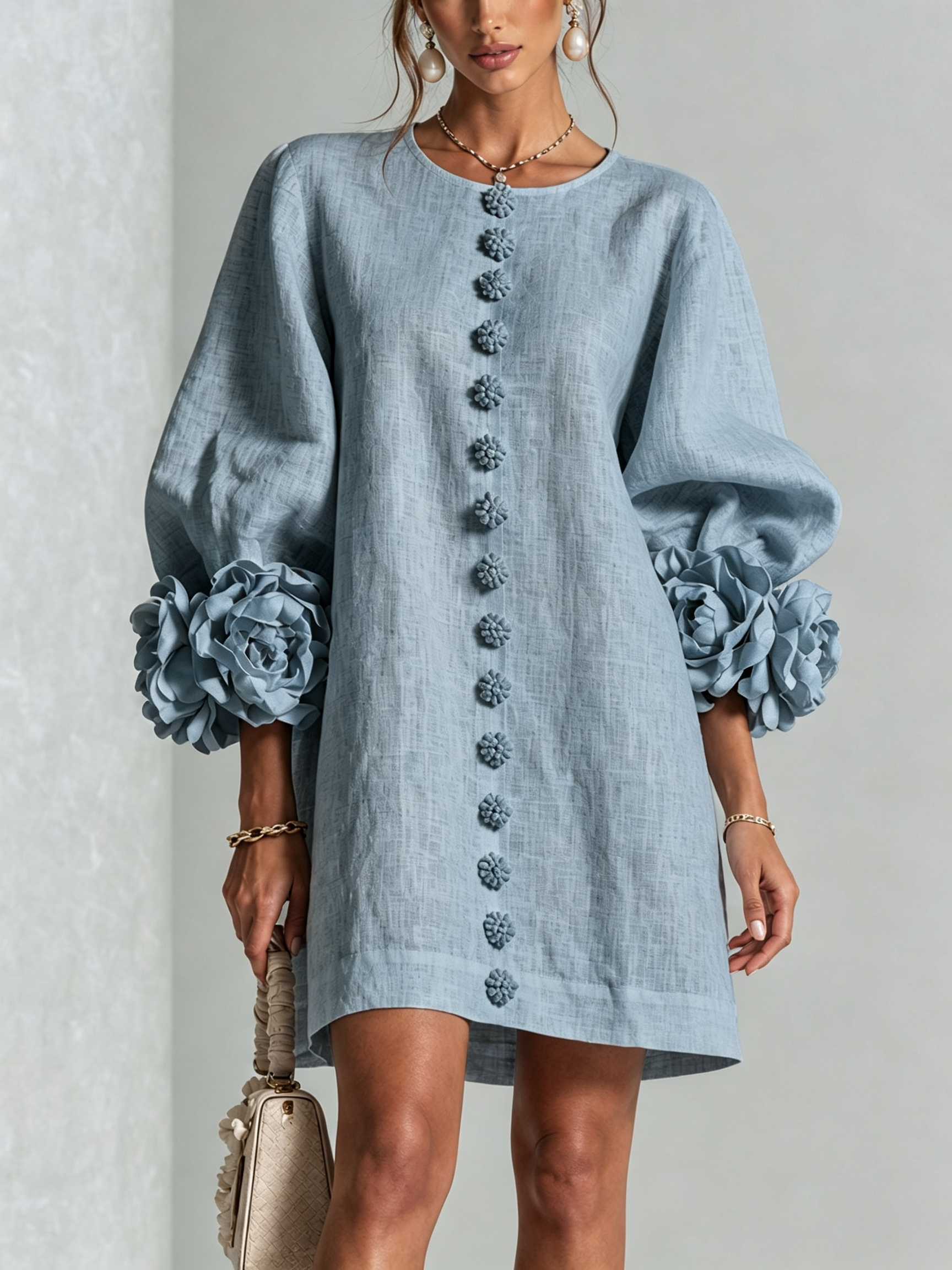 Light blue button-front mini dress with embroidered front placket and rosette sleeve cuff details.