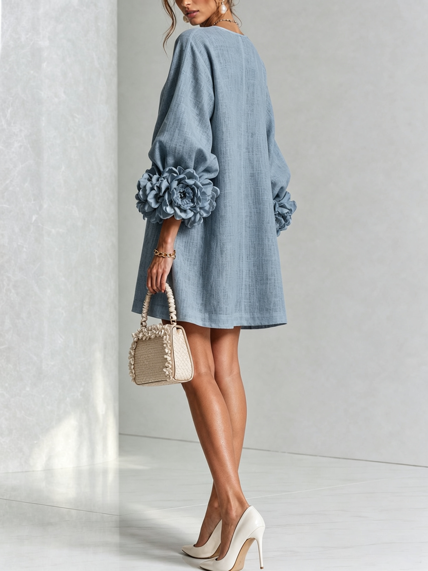 Light blue button-front midi dress with round neckline and rosette puff sleeves
