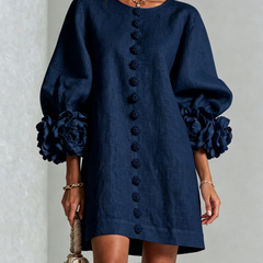 Navy embroidered midi dress with round neck, button trim, and puff sleeves with rose cuffs