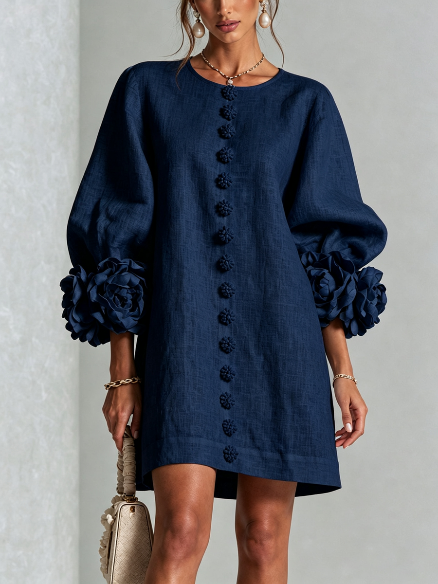 Navy embroidered midi dress with round neck, button trim, and puff sleeves with rose cuffs