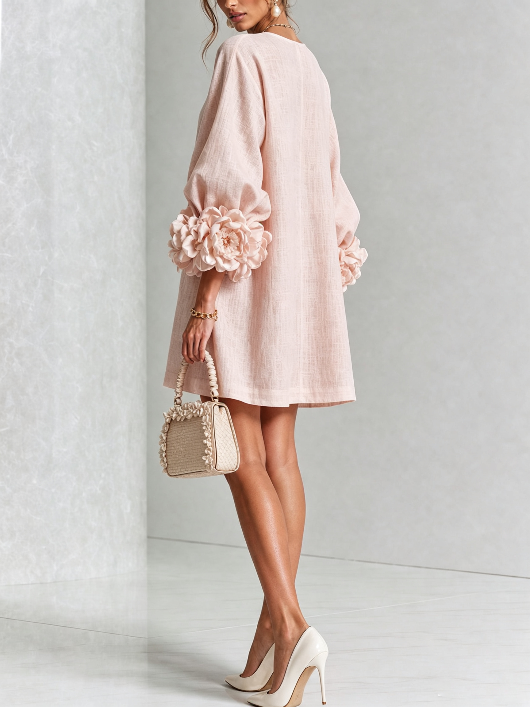 Light pink button-front midi dress with puff sleeves and rosette cuff details