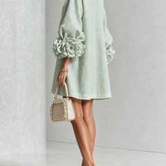 Sage green midi dress with puff sleeves and rosette cuffs, floral placket at center