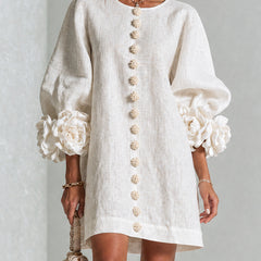 White button-front midi dress with round neckline and puff sleeves with rosette cuffs